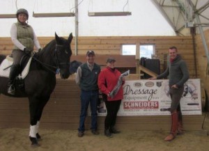 Endel Ots (right) presents Darcy Scarpati (second from right) with a Schneiders Saddlery bridle at Oak Hill Farm in Lockport, Illinios. Charles Pinnell of Schneiders Saddlery (second from left) was on hand to present the award.  (Photo courtesy of Charles Pinnell)