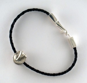 Just in time for Holiday Gifting for your favorite Equestrian, a unique and affordable specialty piece; Tempi Design Studio presents the Hoof: a double sided hoof bead.  Add it to your Pandora Bracelet, wear it as a pendant on our fine leather cords, or our colorful braided leather bracelets.  Tempi’s Hoof Bead is available in Sterling Silver for $39, and our yellow alloy “Golde” mix or rose tinted Ancient Casting Bronze for $29. Toggle type clasp is easy to attach one handed and stays put. Leather is cut to fit an average wrist, but can be adjusted for any size wrist.   www.TempiDesignStudio.com   in the new additions category.   Free Shipping through Dec  16. Use code HOL13 for a special offer.